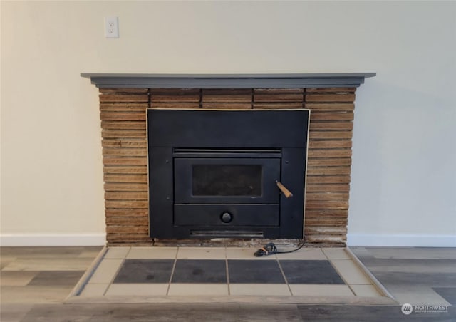 details with wood-type flooring and a wood stove