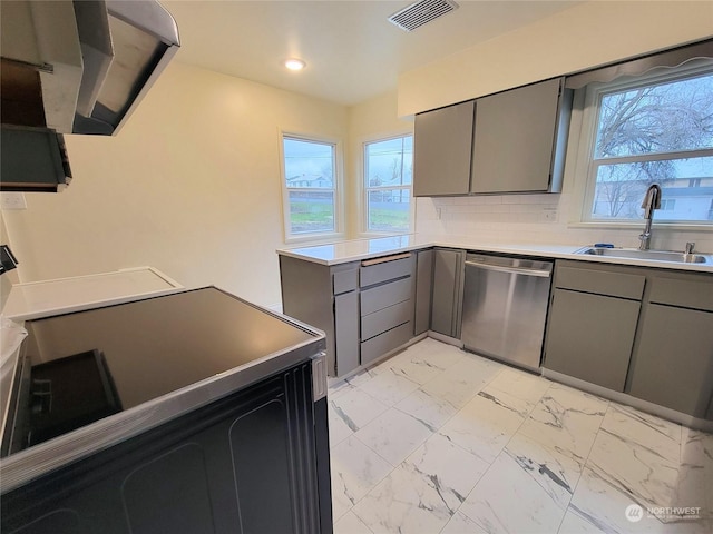 kitchen featuring dishwasher, backsplash, a healthy amount of sunlight, and sink