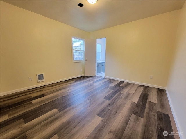 spare room featuring dark hardwood / wood-style flooring