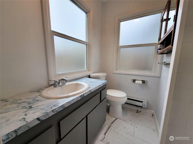 bathroom with vanity, toilet, and a baseboard heating unit