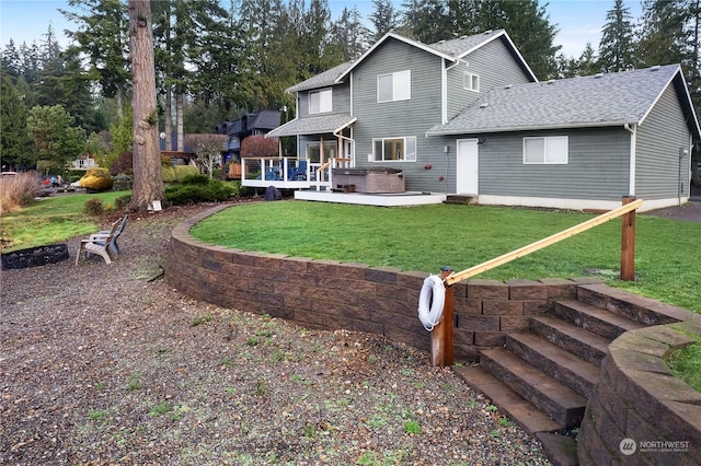 rear view of property featuring a deck and a lawn