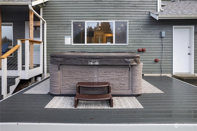 wooden deck featuring a hot tub