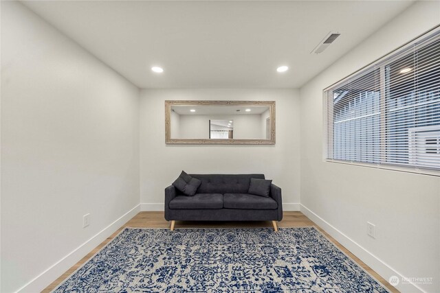 sitting room with hardwood / wood-style flooring