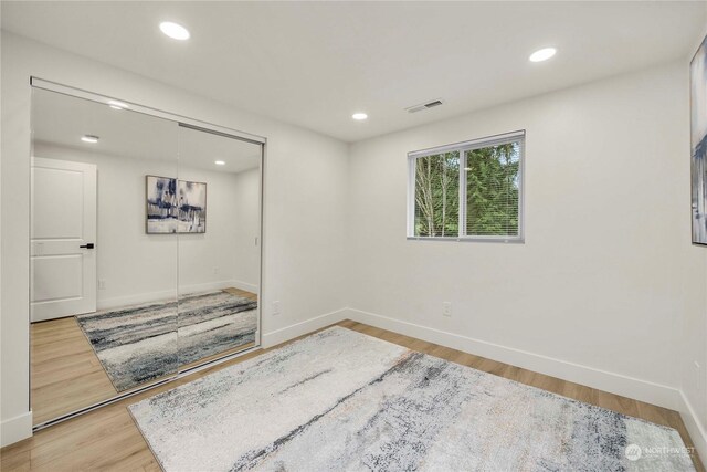 spare room with wood-type flooring