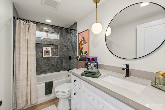 full bathroom with vanity, shower / bathtub combination with curtain, wood-type flooring, and toilet