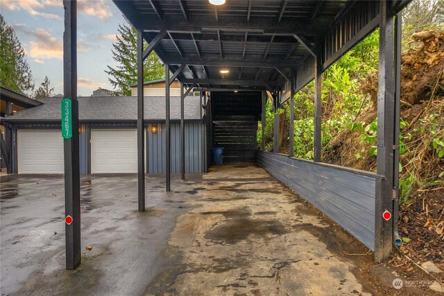 parking at dusk with a carport and a garage