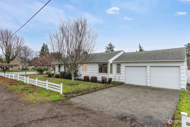 ranch-style house featuring a garage and a front lawn