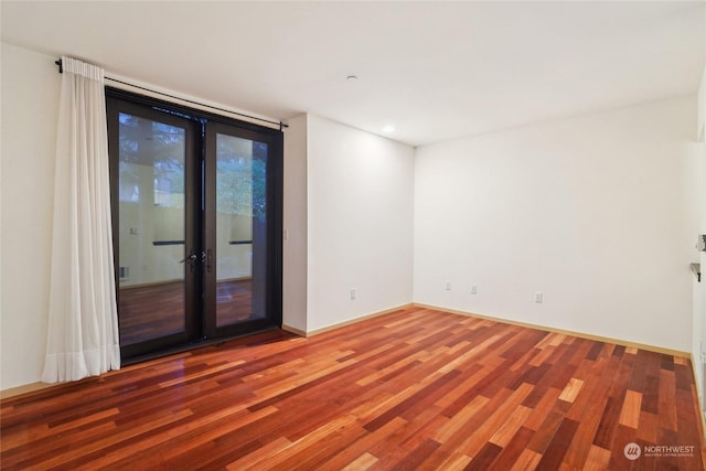 spare room with hardwood / wood-style floors