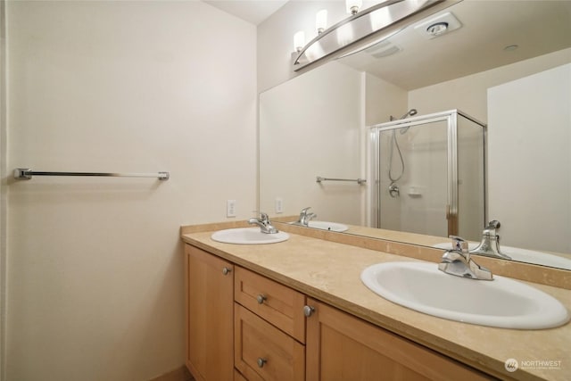 bathroom featuring vanity and an enclosed shower