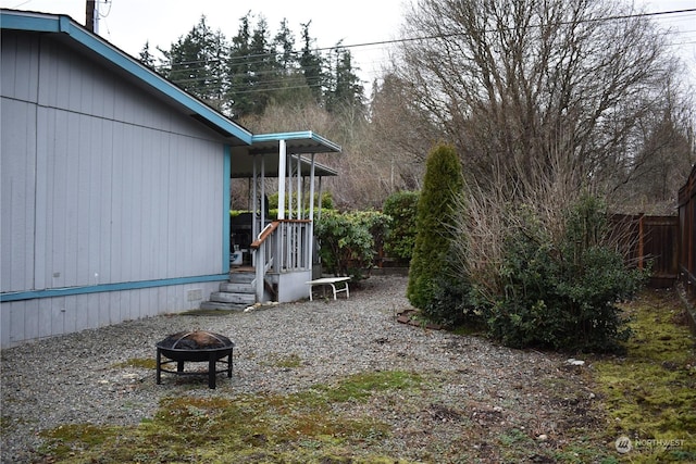 view of yard with an outdoor fire pit