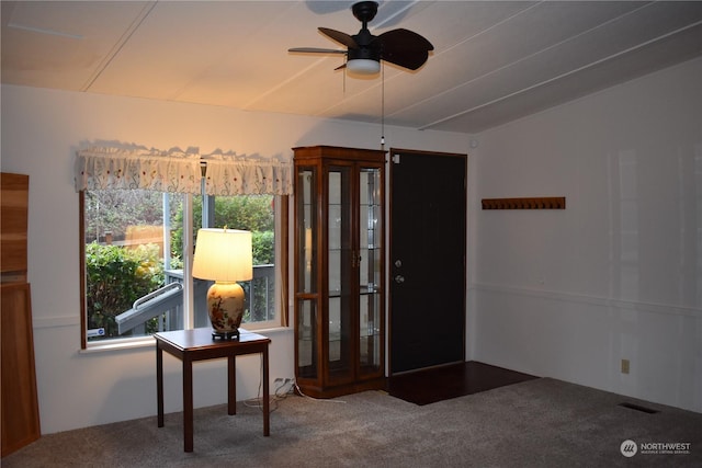 interior space with ceiling fan and carpet floors