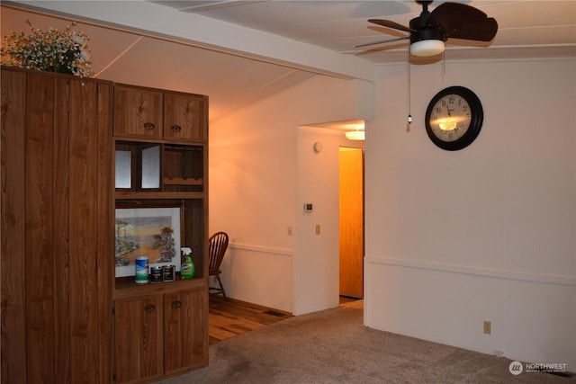 interior space with ceiling fan and lofted ceiling with beams