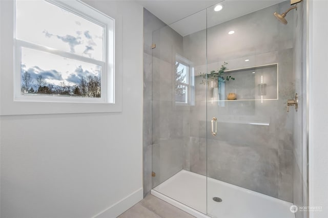 bathroom featuring a shower with shower door