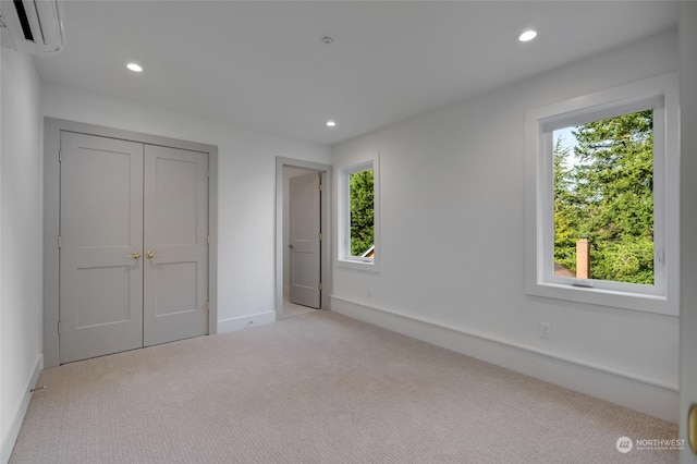 unfurnished bedroom with light carpet and multiple windows