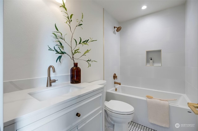 full bathroom with toilet, vanity, and tiled shower / bath