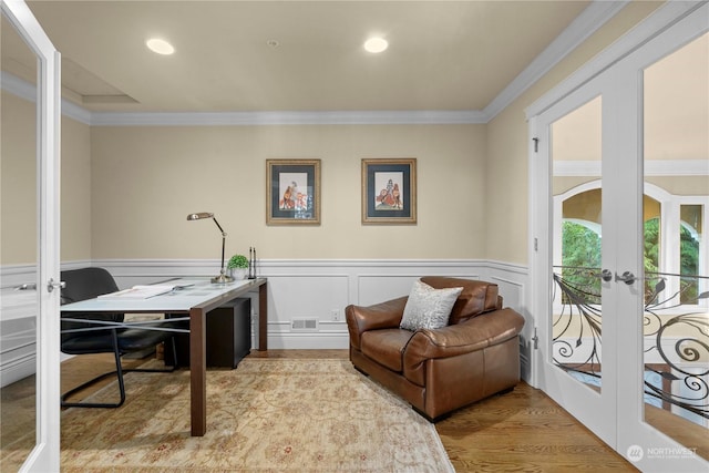 office space with french doors, light wood-type flooring, and crown molding