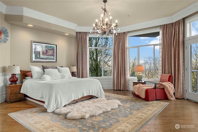 bedroom featuring an inviting chandelier, crown molding, and dark wood-type flooring