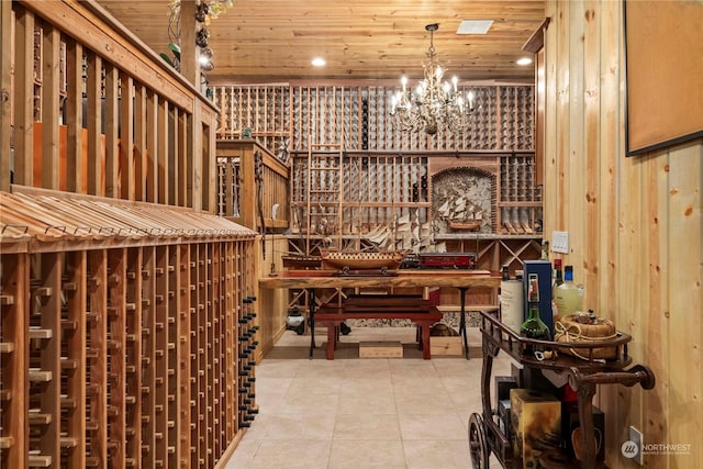 wine room featuring tile patterned floors, a notable chandelier, wood ceiling, and wood walls