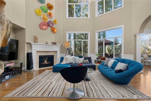 living room with a high ceiling and light wood-type flooring