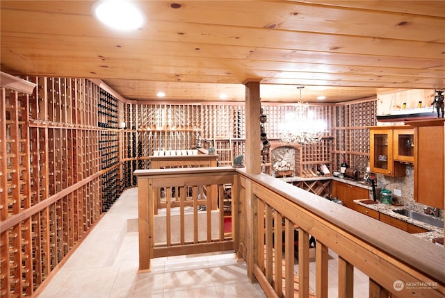 wine room featuring a notable chandelier and wood ceiling