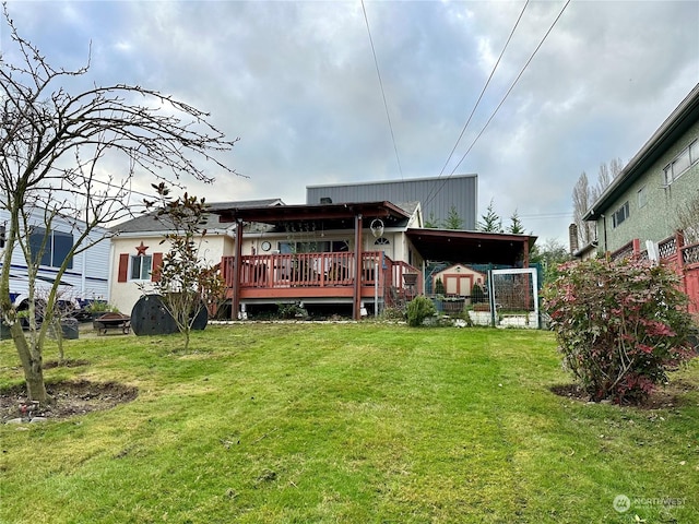 rear view of house with a wooden deck, a lawn, and a carport