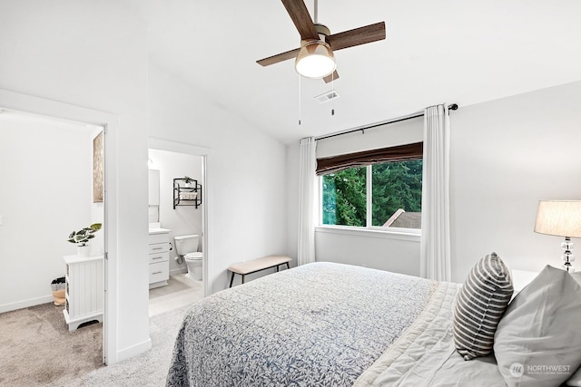 carpeted bedroom featuring ceiling fan, connected bathroom, and vaulted ceiling