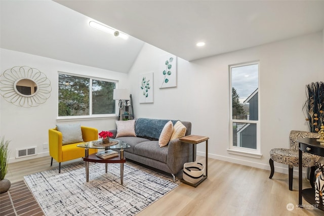 living room featuring light hardwood / wood-style flooring and lofted ceiling