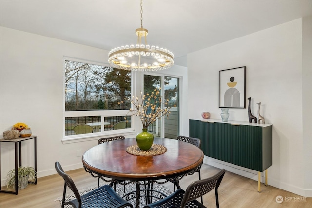 dining space featuring a chandelier and light hardwood / wood-style floors