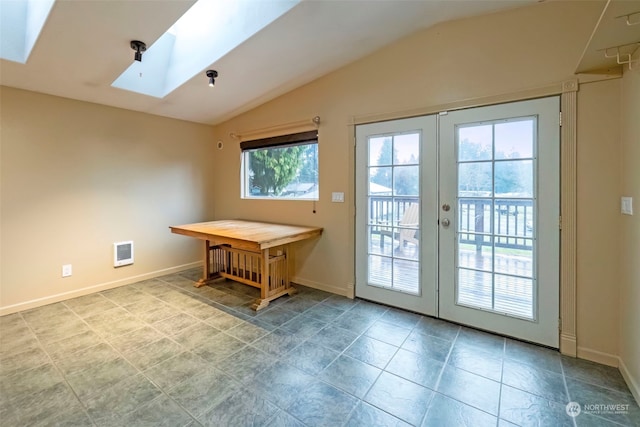 doorway to outside featuring vaulted ceiling with skylight, french doors, visible vents, and baseboards