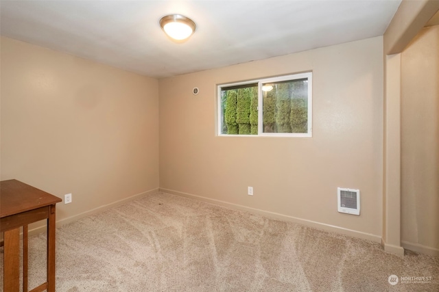 carpeted spare room with baseboards and visible vents