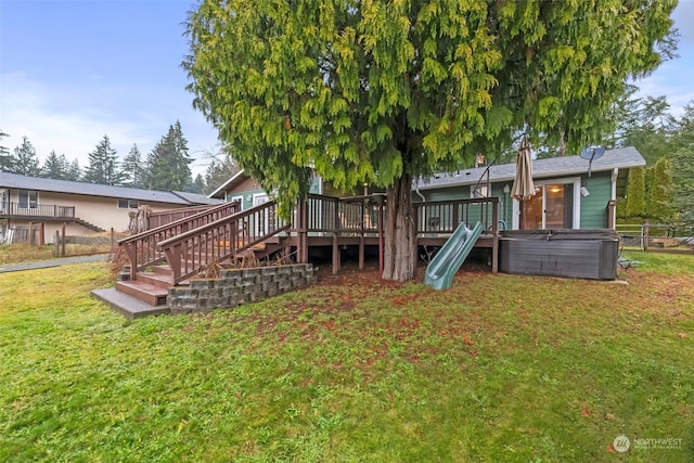 view of yard featuring stairway, a wooden deck, and a hot tub