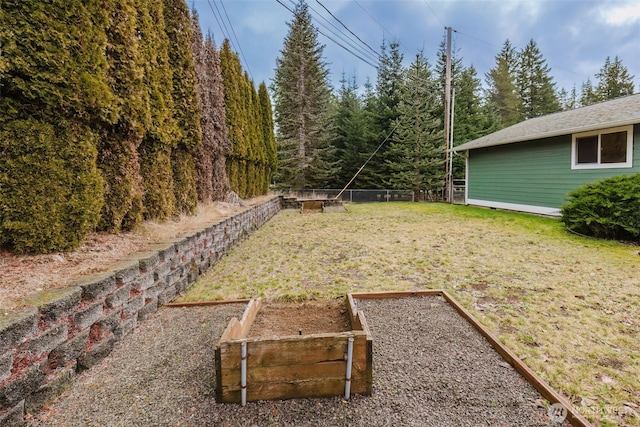 view of yard with a garden and fence