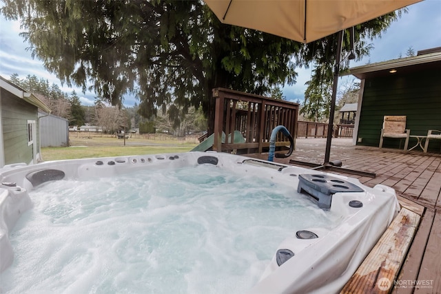 wooden deck featuring hot tub deck surround