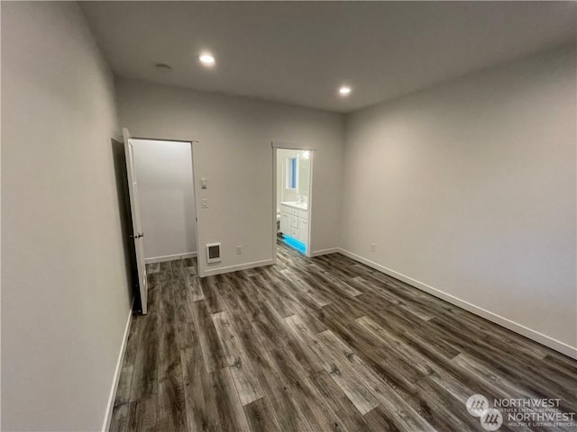 unfurnished room featuring dark wood-type flooring