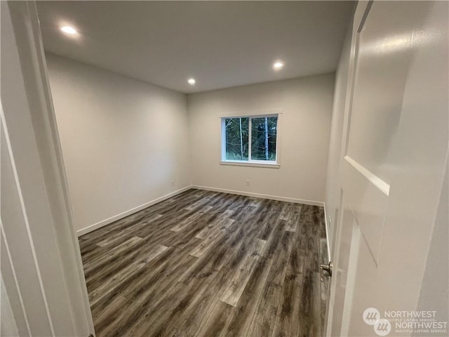 unfurnished room with dark wood-type flooring