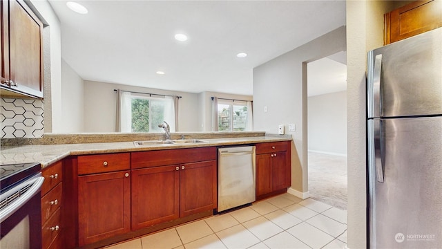 kitchen featuring stainless steel fridge, sink, light tile patterned flooring, and dishwashing machine