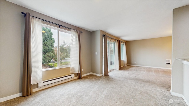 carpeted spare room with plenty of natural light and baseboard heating