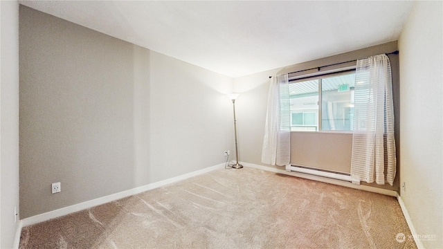 carpeted empty room with a baseboard radiator