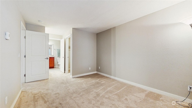 spare room with light colored carpet