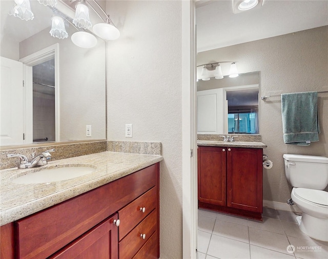 bathroom featuring tile patterned flooring, vanity, and toilet