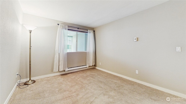 unfurnished room with light colored carpet and a baseboard heating unit