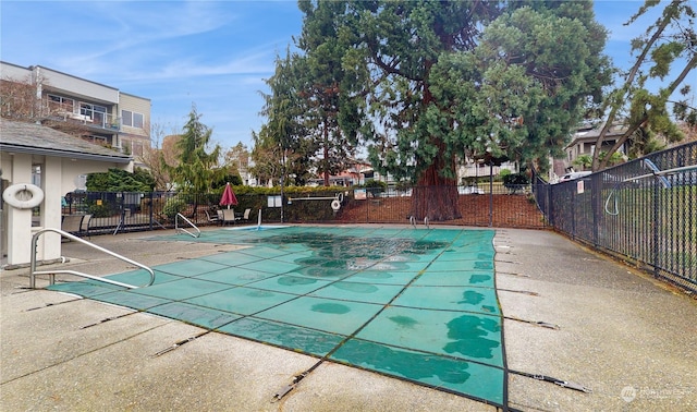 view of swimming pool featuring a patio area