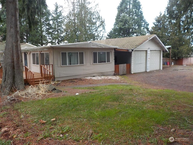 view of front of home with a front yard and a garage