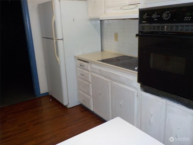 kitchen featuring white cabinetry, tasteful backsplash, black appliances, and dark hardwood / wood-style floors