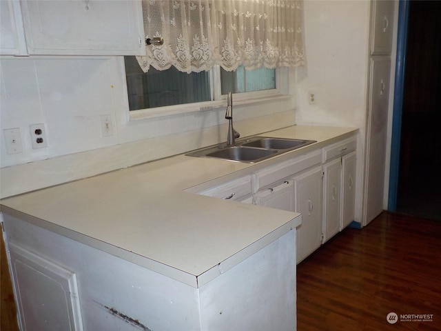 kitchen with sink, white cabinetry, and dark wood-type flooring