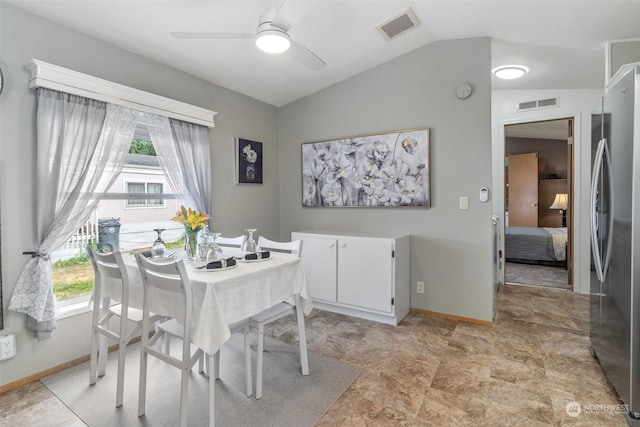 dining space with ceiling fan and lofted ceiling