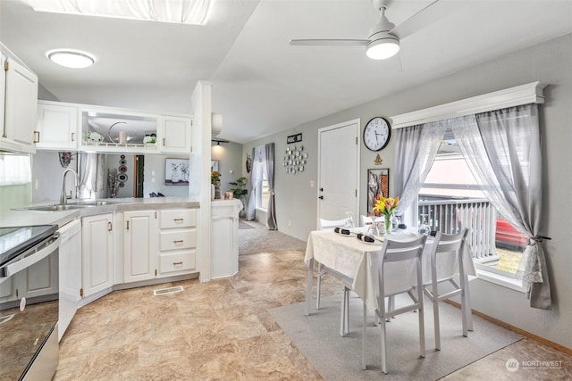 kitchen with vaulted ceiling, ceiling fan, sink, electric range, and white cabinets