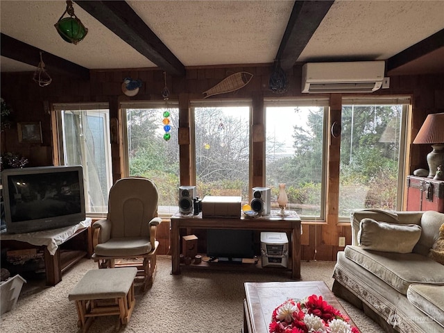 4757 State Route 109, Moclips, WA 98562 - living room featuring a wall unit AC, wood walls, beam ceiling, a textured ceiling, and carpet