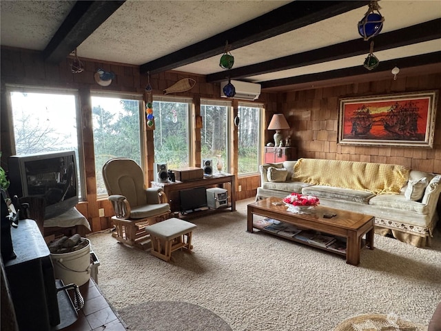 4757 State Route 109, Moclips, WA 98562 - living area featuring wooden walls, beam ceiling, a wall mounted air conditioner, plenty of natural light, and a textured ceiling