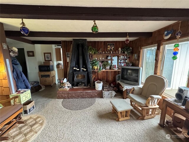 4757 State Route 109, Moclips, WA 98562 - living room with a wood stove, beamed ceiling, and wooden walls